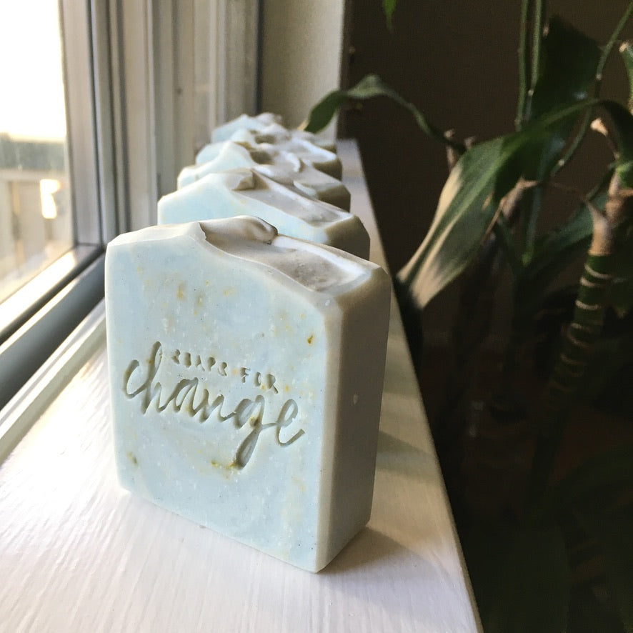 Baby blue soap with specks of natural green, stamped with 
