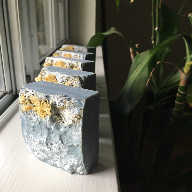 Blue square-shaped soap bar decorated with dried flowers